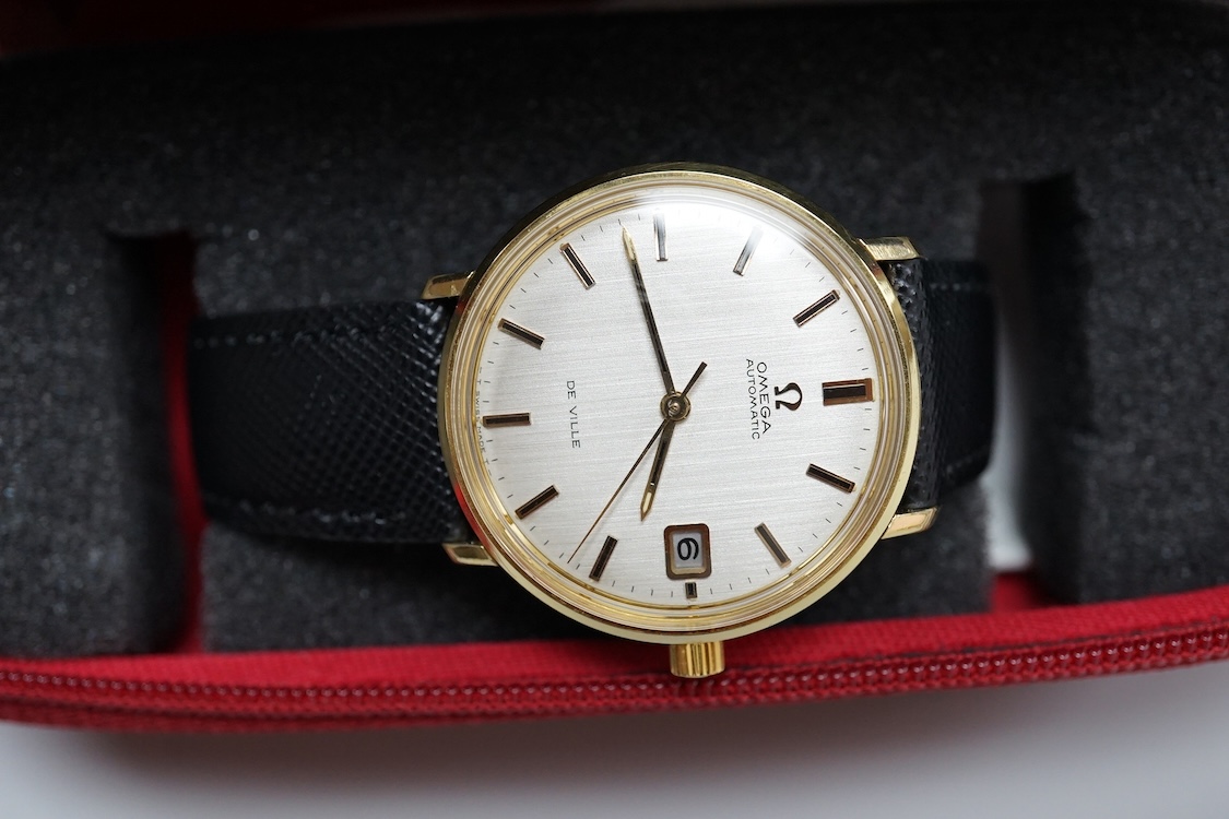 A gentleman's gold plated Omega De Ville automatic wrist watch, with baton numerals and date aperture, case diameter 35mm, on an associated strap, with Omega case.